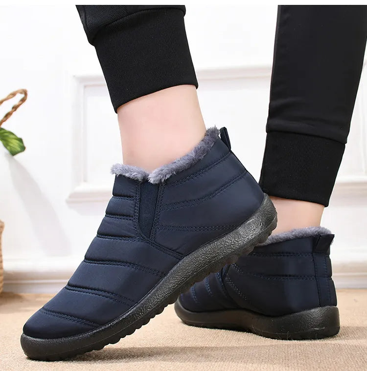 Callum navy ankle snow boots worn on model, close-up ankle view