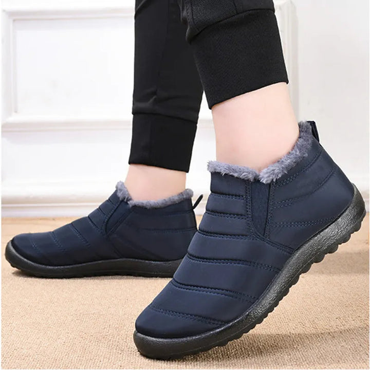 Callum navy ankle snow boots worn on model, walking pose