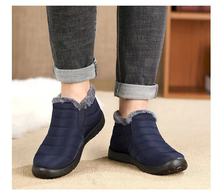 Callum navy ankle snow boots worn on model, newspaper background