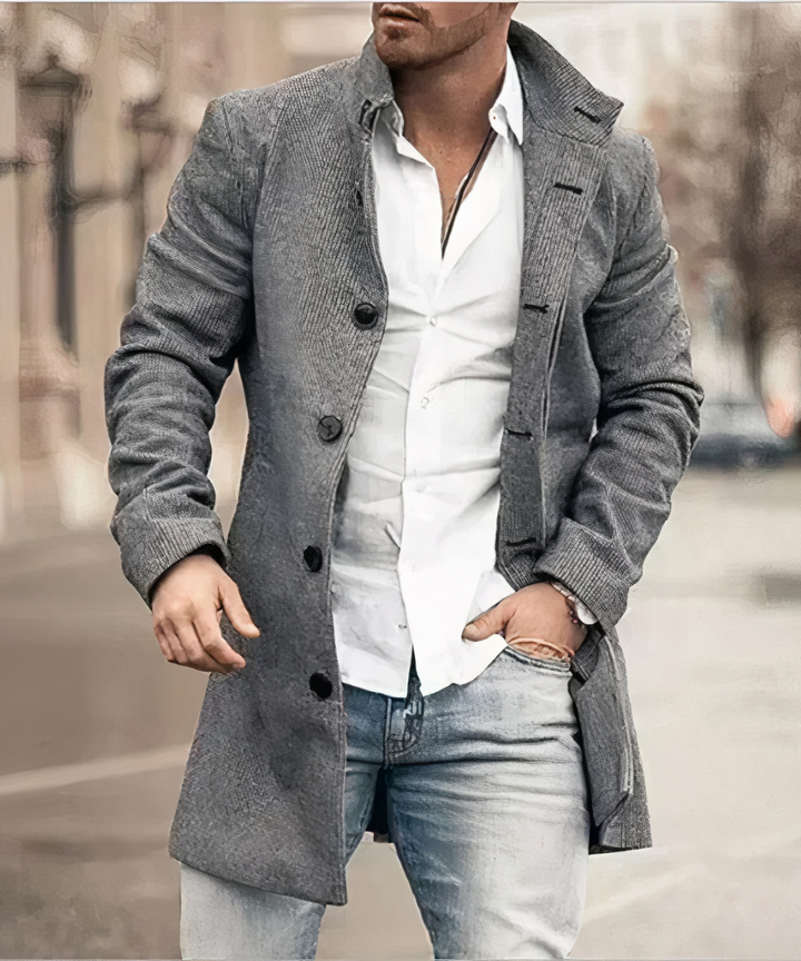 Holden trench coat in gray textured fabric worn on city street, front view