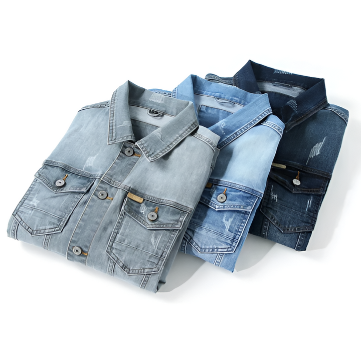 Three folded denim jackets showing collars in grey, light blue, and dark blue
