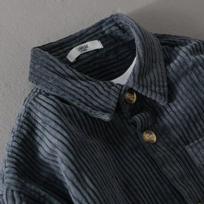 Close-up of Julian corduroy shirt collar and button detail in dark blue