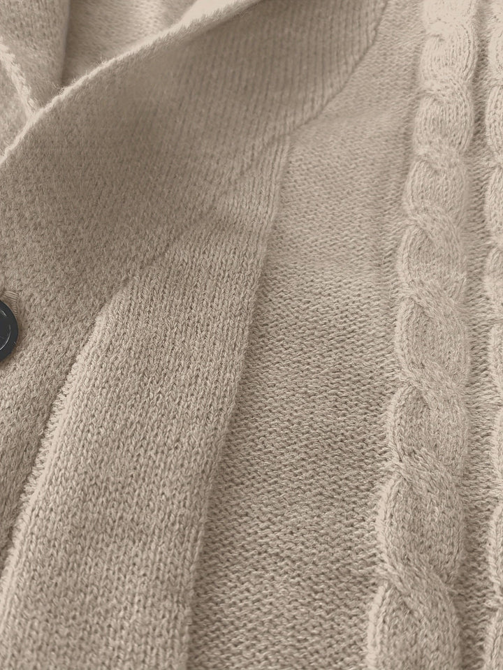 Close-up of beige cable knit fabric texture and button detail