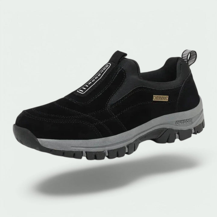 Thaddeus orthopedic slip-on walking sneaker in black suede, floating side angle view