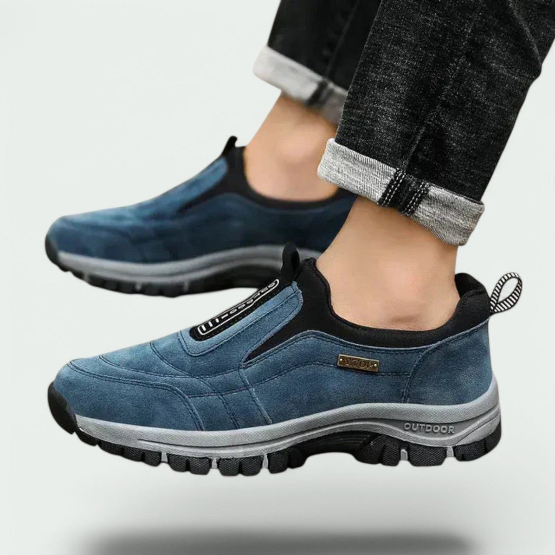 Thaddeus orthopedic slip-on walking sneakers worn on feet with rolled jeans